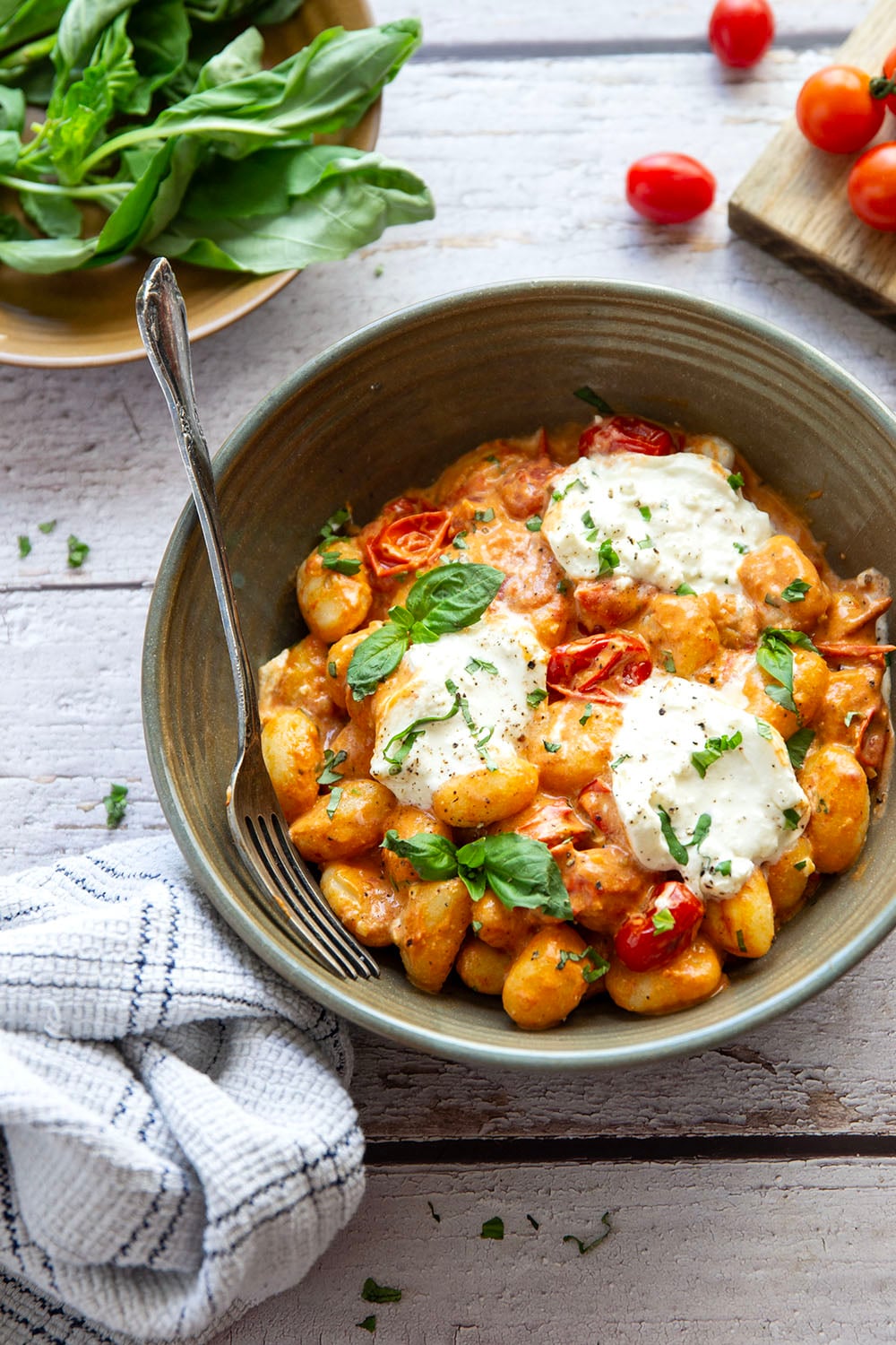 A creamy fresh cherry tomato sauce coats every inch of pillowy gnocchi in this summery burst tomato gnocchi that's topped with lots of fresh basil and rich burrata cheese.
