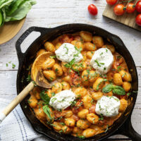 A creamy fresh cherry tomato sauce coats every inch of pillowy gnocchi in this summery burst tomato gnocchi that's topped with lots of fresh basil and rich burrata cheese.