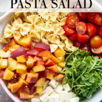 Sweet peaches pair perfectly with herby basil, soft mozzarella, juicy cherry tomatoes, and a tangy balsamic dressing in this peach caprese pasta salad.