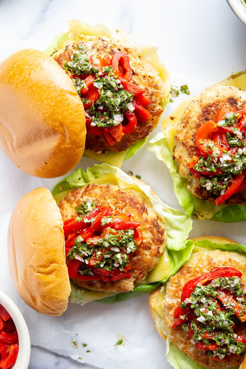 Topped with tender roasted red peppers and a flavorful chimichurri sauce, these cheddar turkey burgers are the perfect summer sandwich.