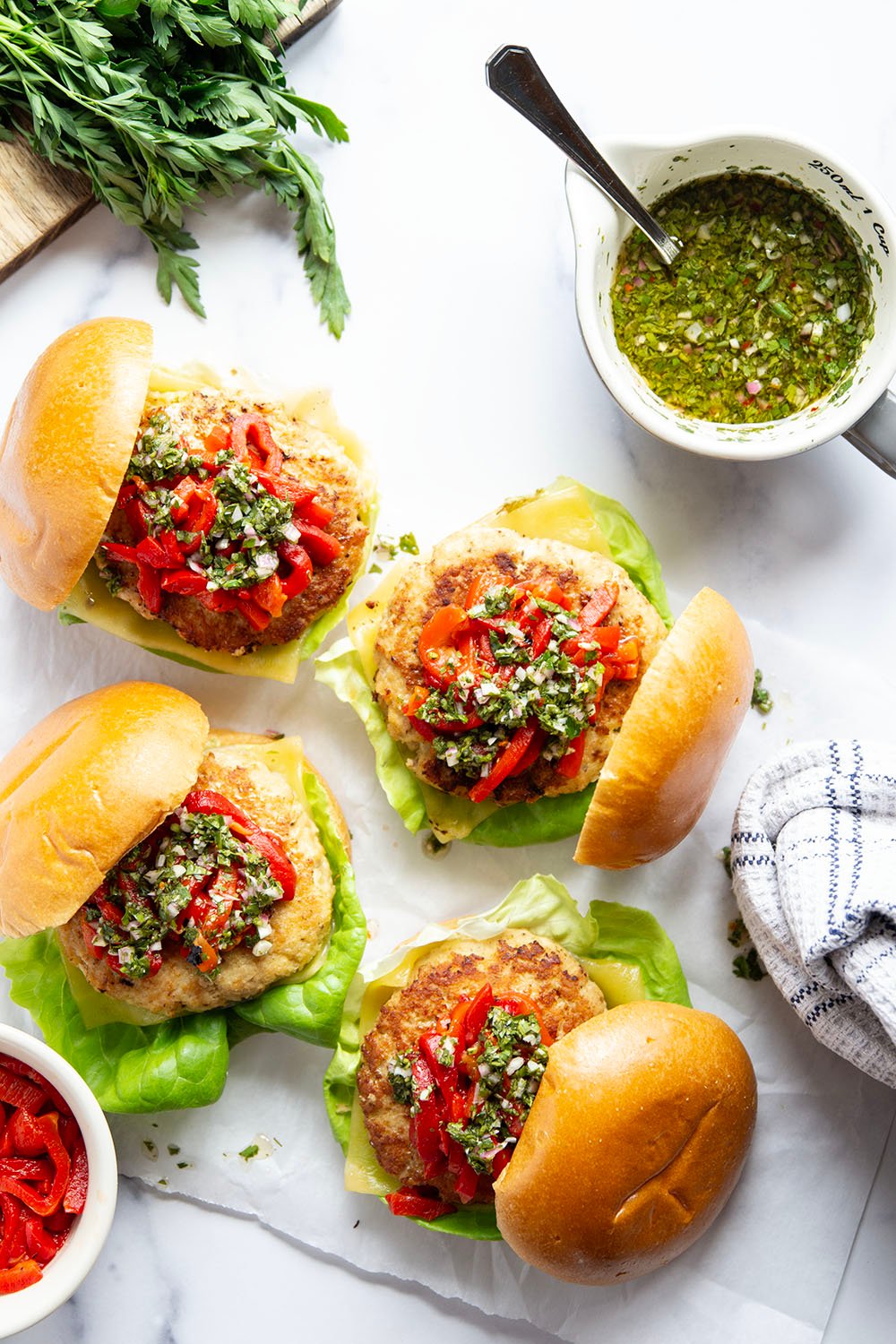 Topped with tender roasted red peppers and a flavorful chimichurri sauce, these cheddar turkey burgers are the perfect summer sandwich.