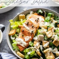Buttery seared salmon fillets are the perfect meat pairing in this protein-packed seared salmon Caesar salad that features a creamy roasted garlic dressing on top.
