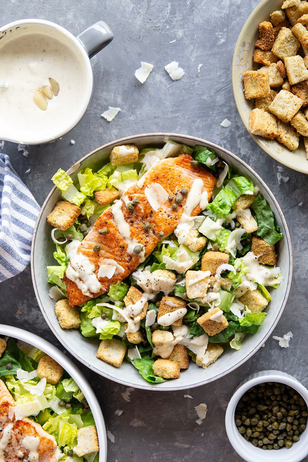 Buttery seared salmon fillets are the perfect meat pairing in this protein-packed seared salmon Caesar salad that features a creamy roasted garlic dressing on top.