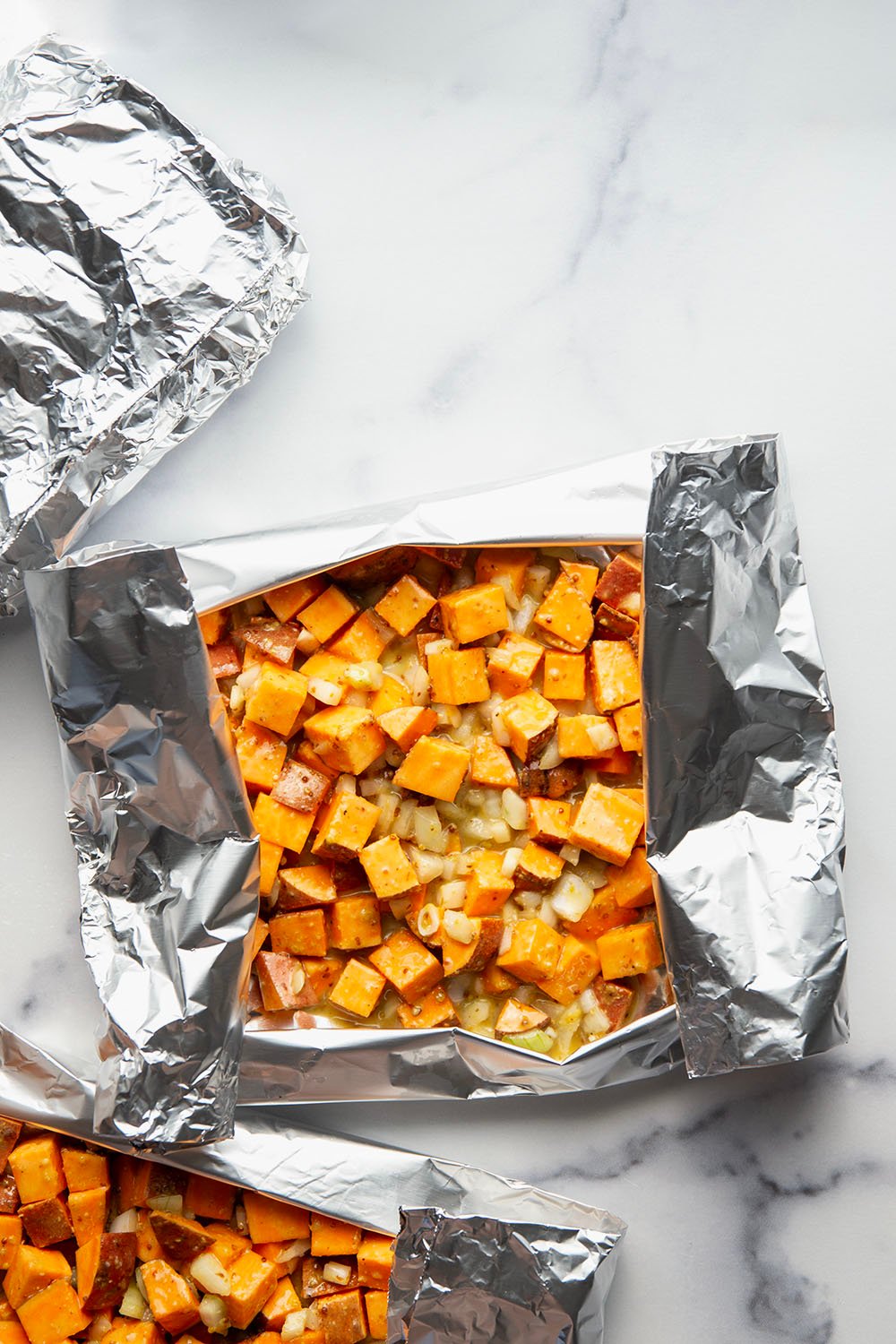 Tossed in a homemade honey mustard and grilled to tender, smoky perfection in foil packets, these grilled sweet potatoes in foil are an easy side dish to throw on the grill for any occasion.