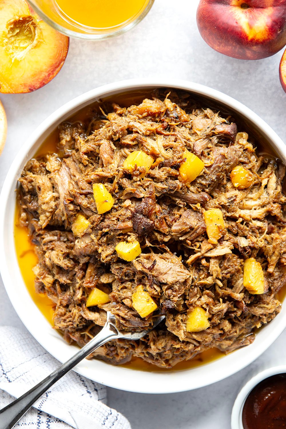 Slowly braised in sweet peaches and spicy hot honey, this peach hot honey pulled pork is fall-apart tender and makes one incredible sandwich!
