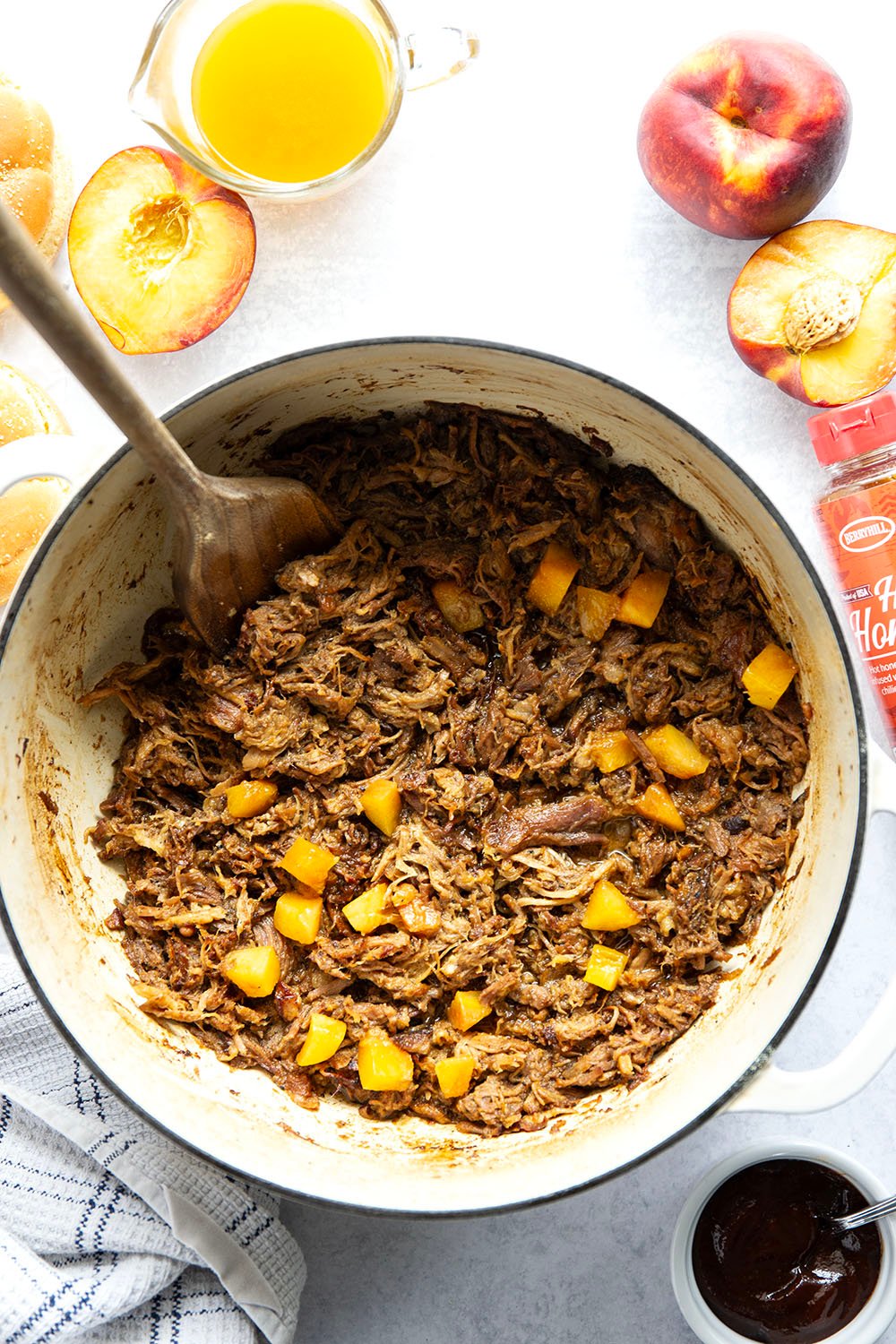 Slowly braised in sweet peaches and spicy hot honey, this peach hot honey pulled pork is fall-apart tender and makes one incredible sandwich!