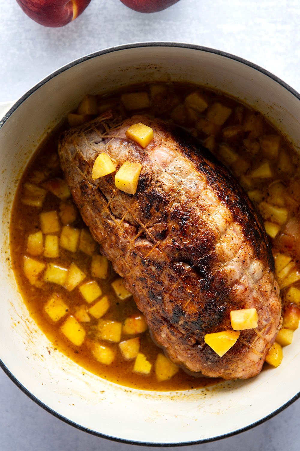 Slowly braised in sweet peaches and spicy hot honey, this peach hot honey pulled pork is fall-apart tender and makes one incredible sandwich!