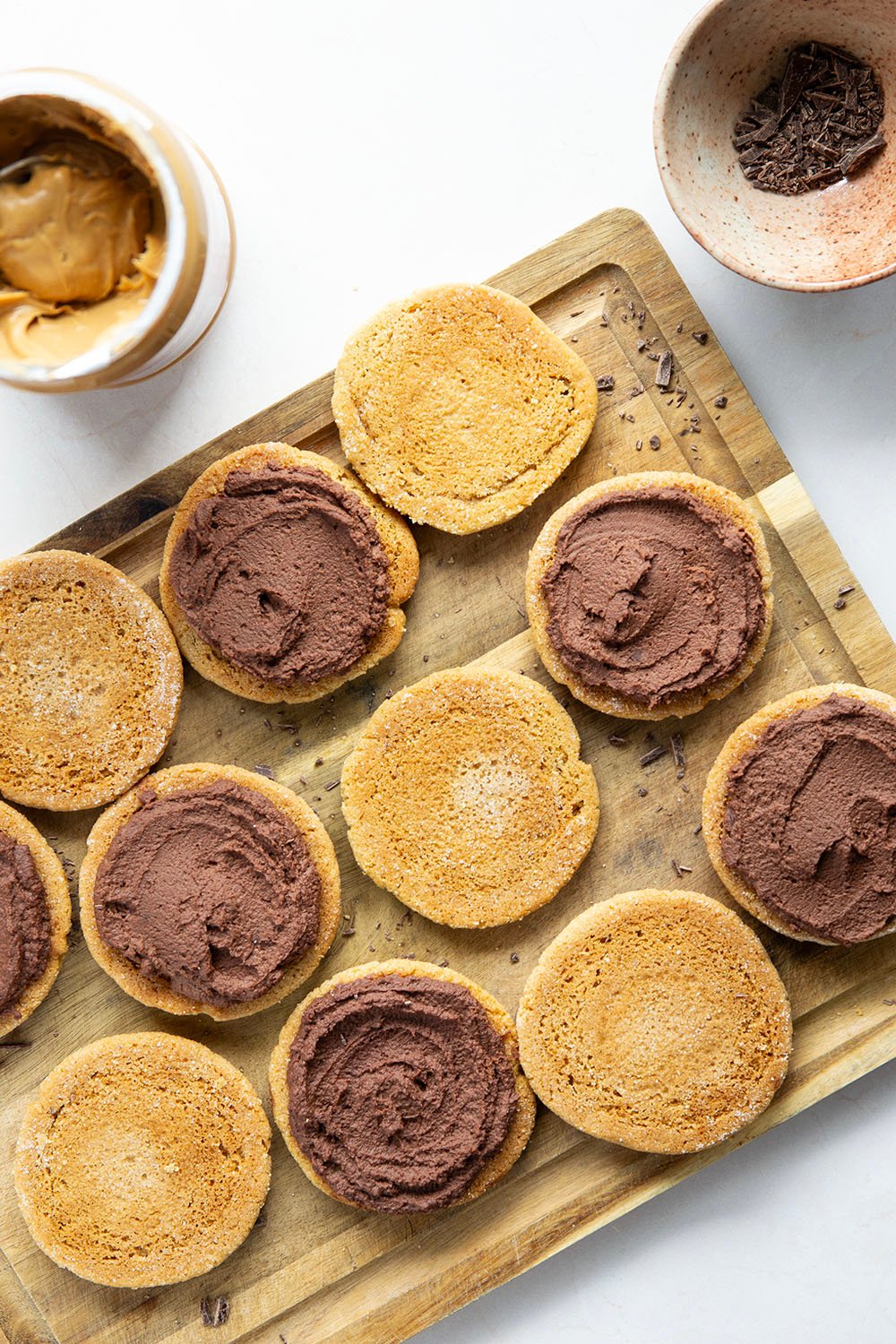 These chocolate peanut butter sandwich cookies feature fluffy whipped chocolate ganache stuffed between light and crispy peanut butter cookies.