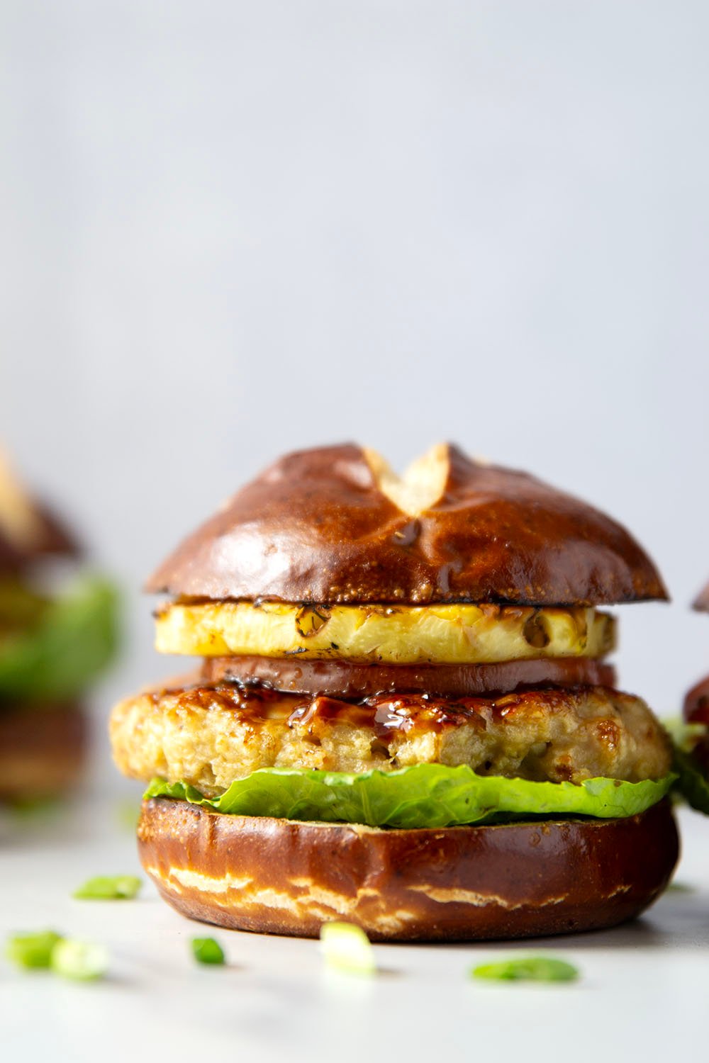 These teriyaki pineapple chicken burgers feature juicy chicken patties brushed with a homemade teriyaki sauce and grilled alongside sweet pineapple rings all piled into an unforgettable burger!