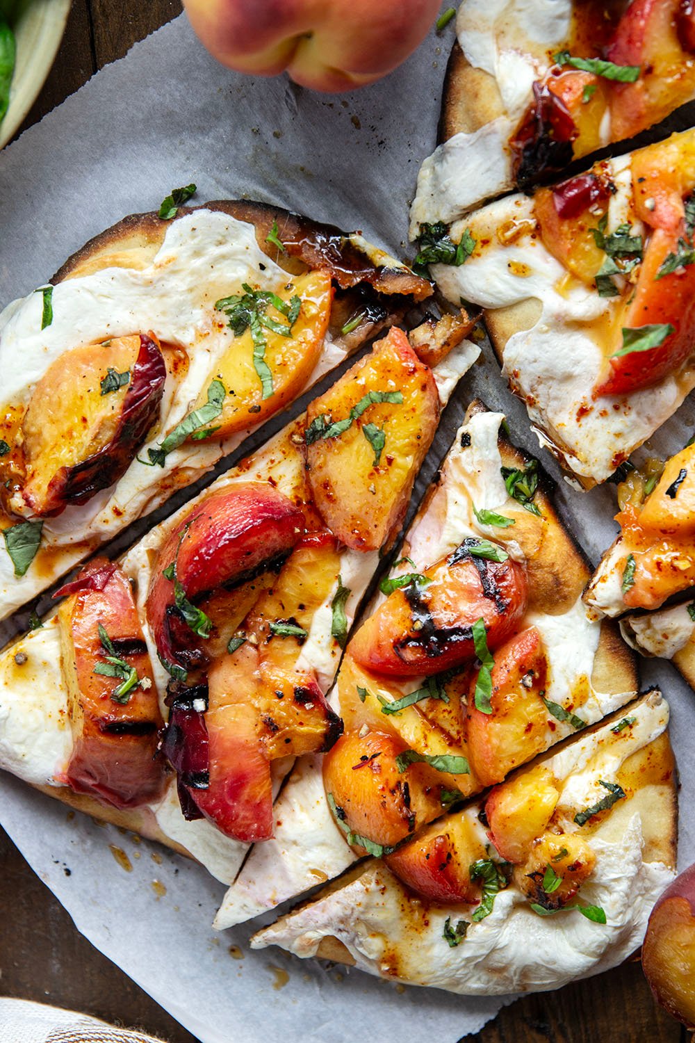 Smoky grilled peaches and drizzles of sweet and spicy homemade hot honey sauce are the perfect duo in this grilled peach flatbread.