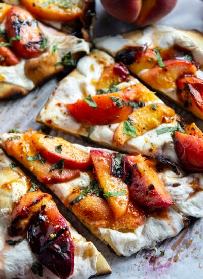 Smoky grilled peaches and drizzles of sweet and spicy homemade hot honey sauce are the perfect duo in this grilled peach flatbread.