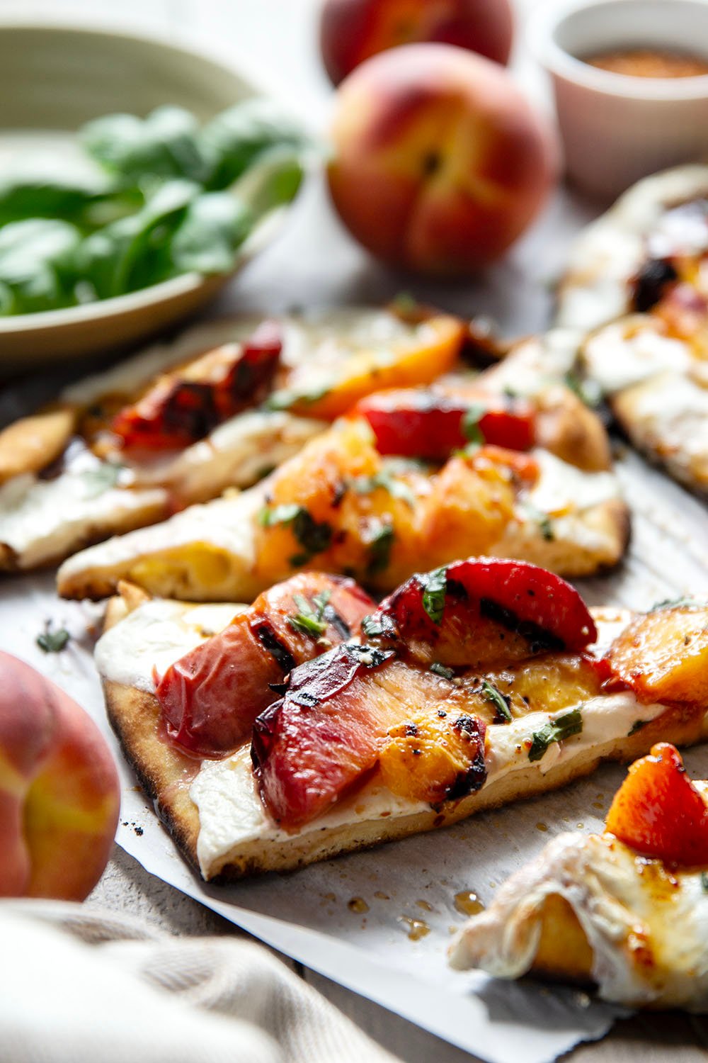 Smoky grilled peaches and drizzles of sweet and spicy homemade hot honey sauce are the perfect duo in this grilled peach flatbread.
