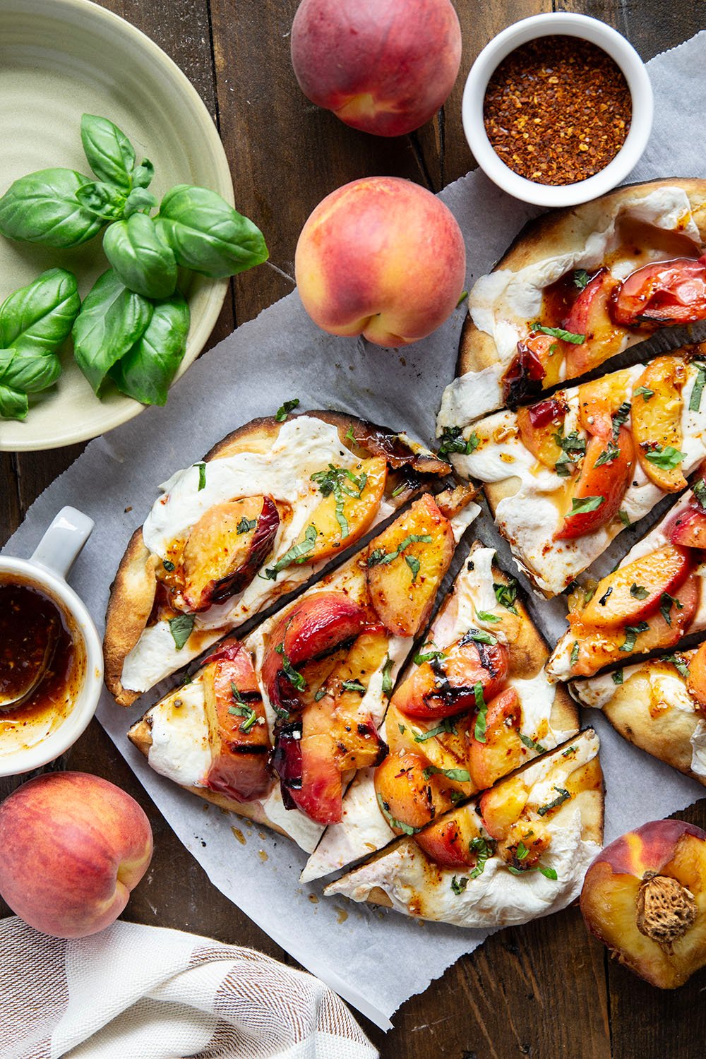 Smoky grilled peaches and drizzles of sweet and spicy homemade hot honey sauce are the perfect duo in this grilled peach flatbread.