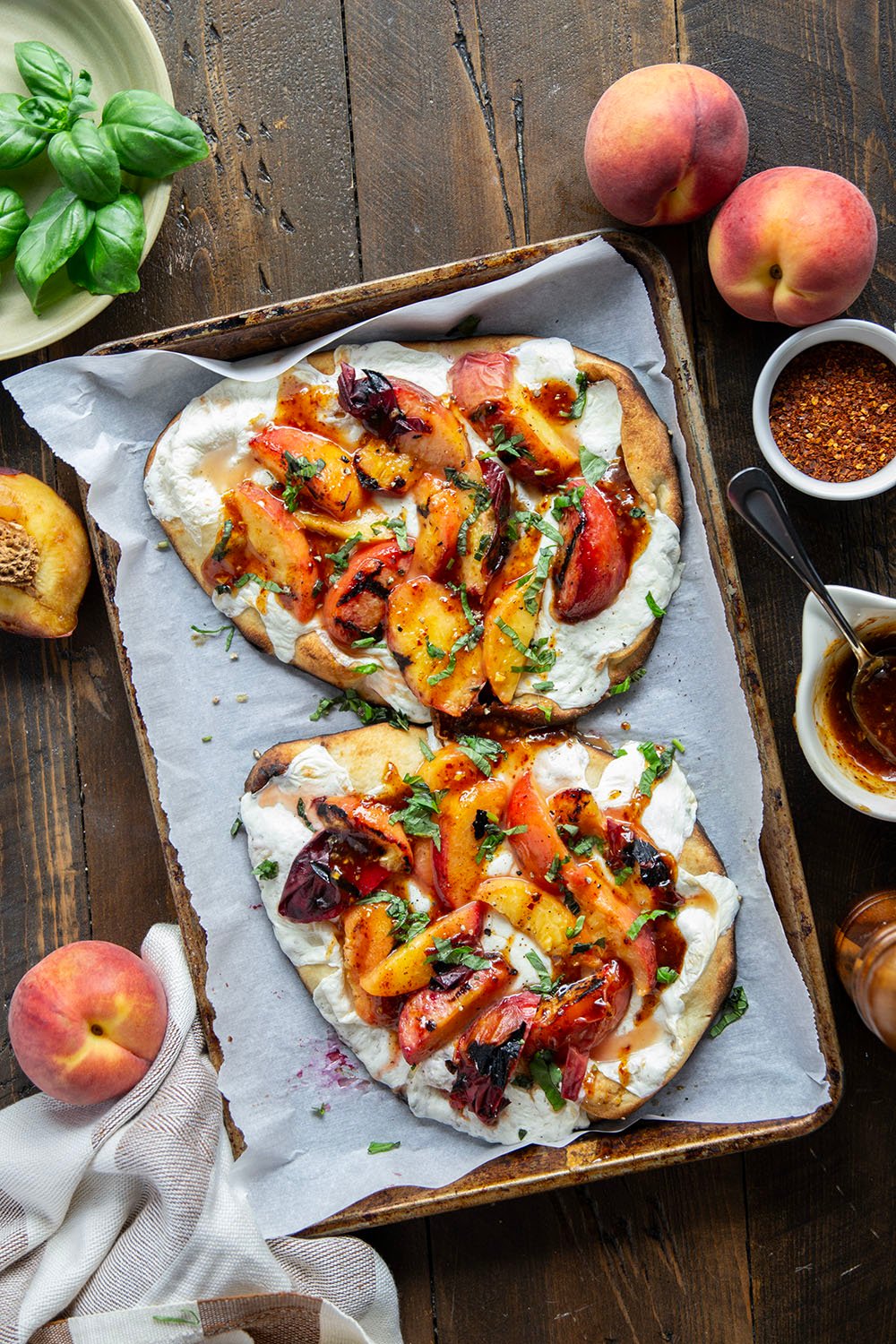 Smoky grilled peaches and drizzles of sweet and spicy homemade hot honey sauce are the perfect duo in this grilled peach flatbread.