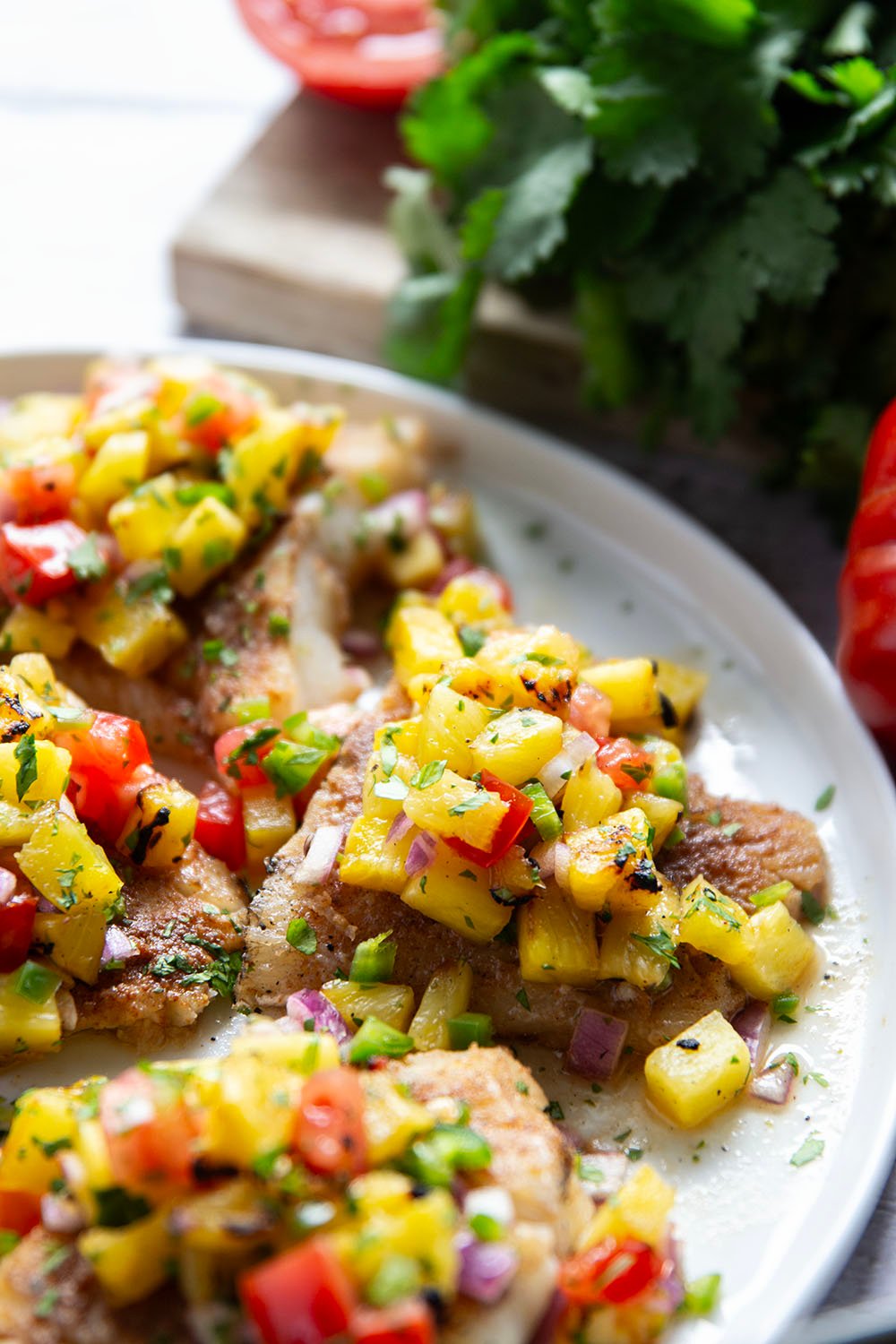 This jerk cod features a homemade jerk seasoning mix rubbed all over cod fillets, grilled to perfection, and topped with a smoky grilled pineapple salsa.
