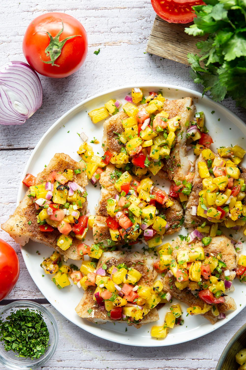This jerk cod features a homemade jerk seasoning mix rubbed all over cod fillets, grilled to perfection, and topped with a smoky grilled pineapple salsa.