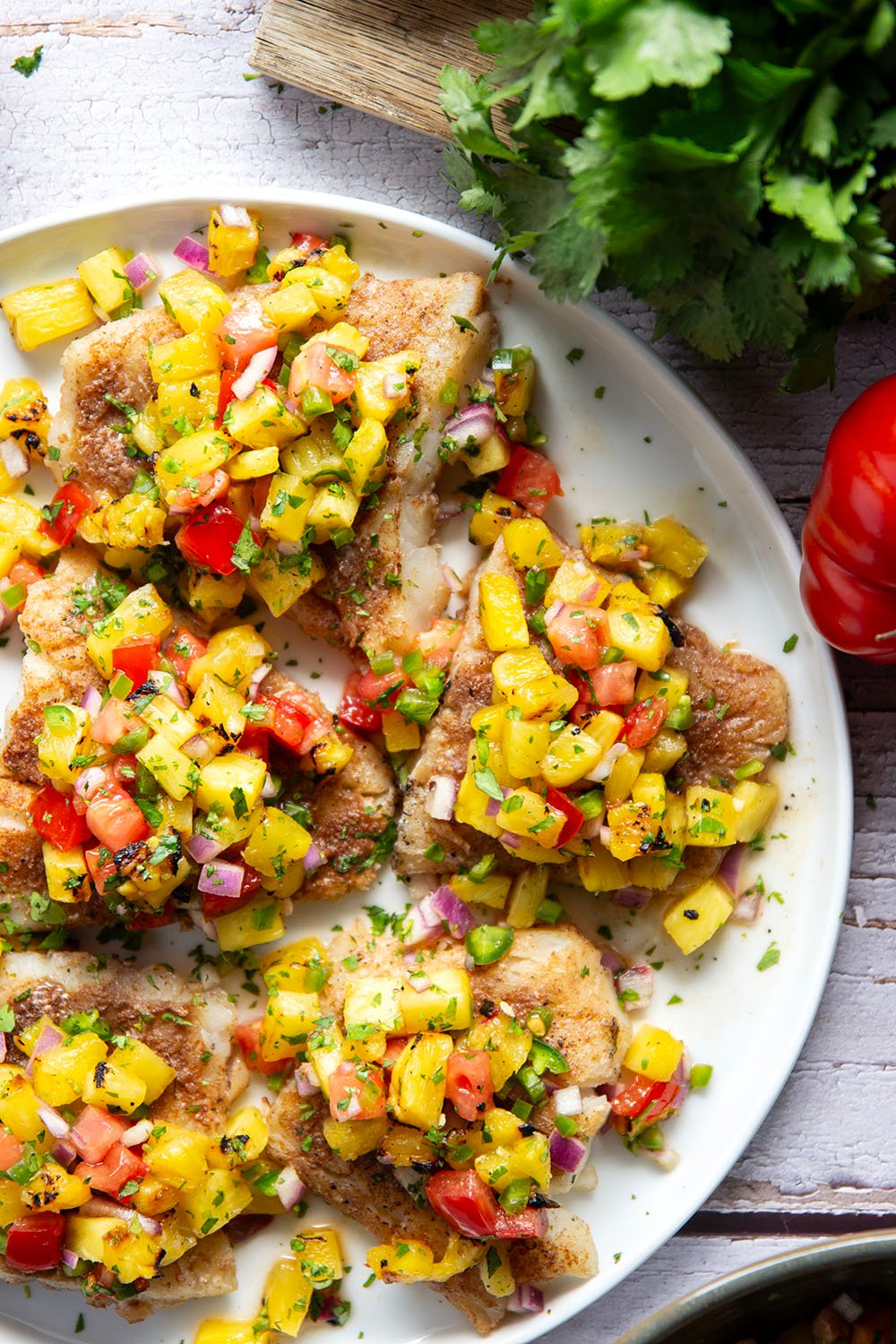 This jerk cod features a homemade jerk seasoning mix rubbed all over cod fillets, grilled to perfection, and topped with a smoky grilled pineapple salsa.