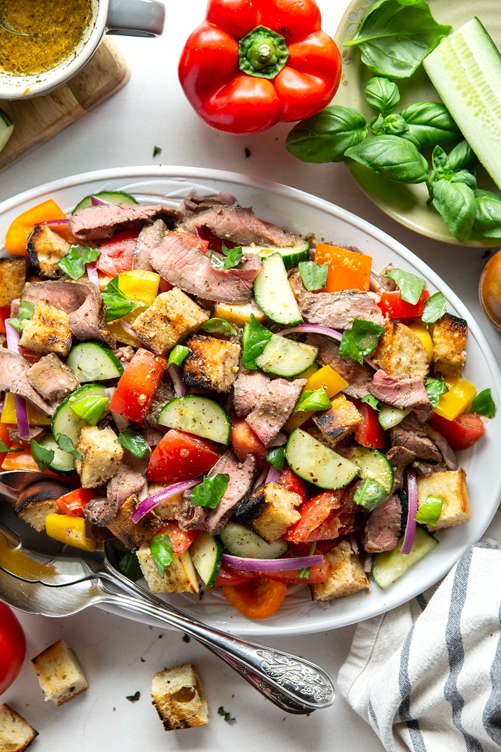 Juicy grilled steak, charred bread cubes, juicy tomatoes, and lots of fresh basil make for the perfect summery meal in this grilled steak panzanella salad.