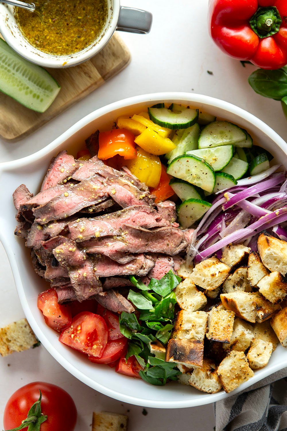 Juicy grilled steak, charred bread cubes, juicy tomatoes, and lots of fresh basil make for the perfect summery meal in this grilled steak panzanella salad.