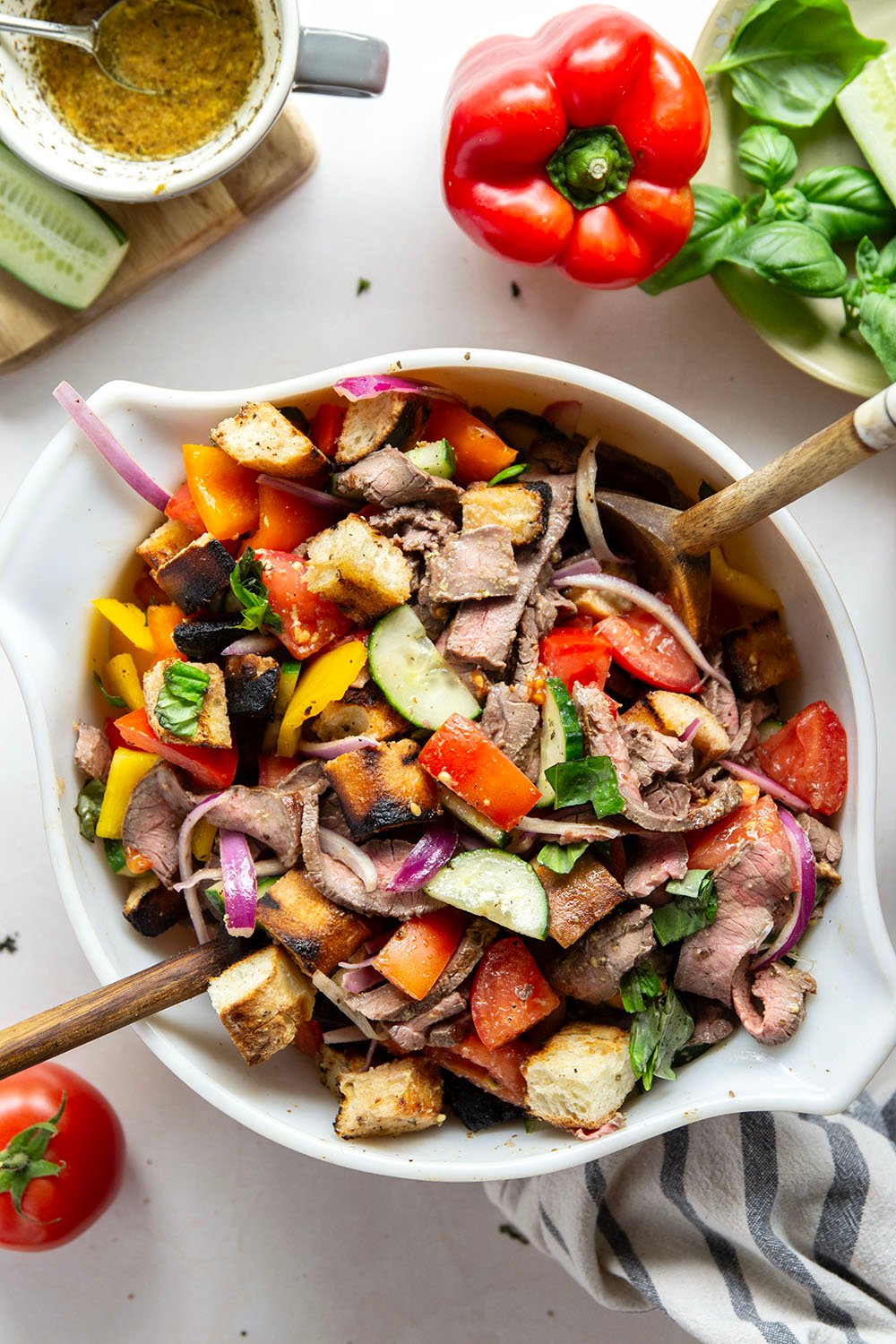 Juicy grilled steak, charred bread cubes, juicy tomatoes, and lots of fresh basil make for the perfect summery meal in this grilled steak panzanella salad.