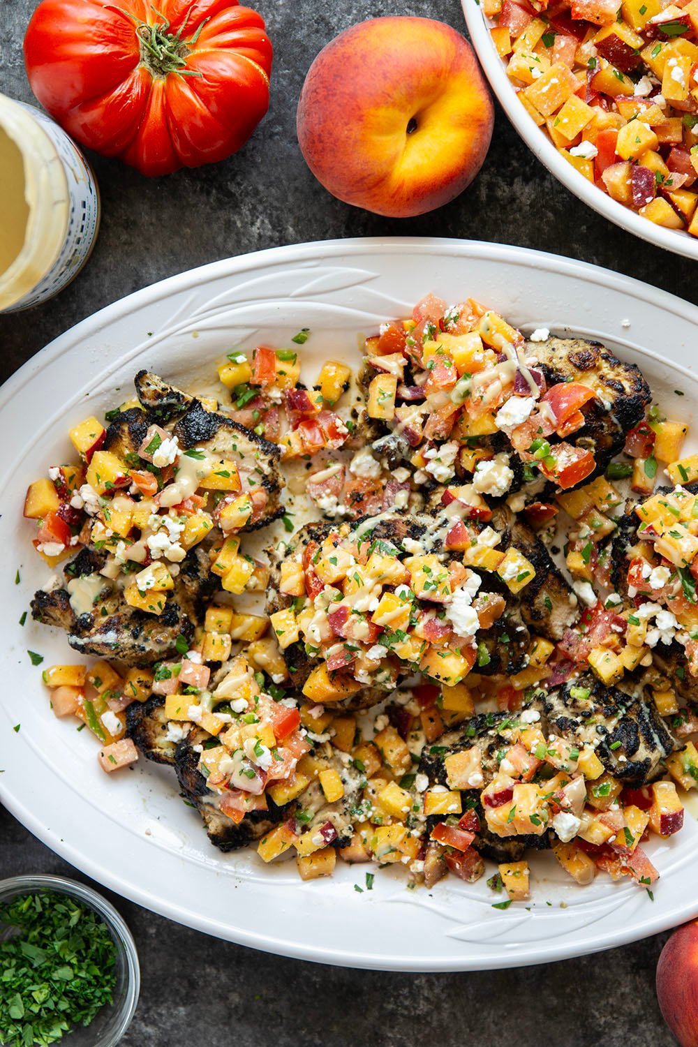 Marinated in a flavorful tahini sauce, grilled to smoky perfection, and topped with a tangy peach feta salsa, this grilled tahini chicken is an explosion of flavors!