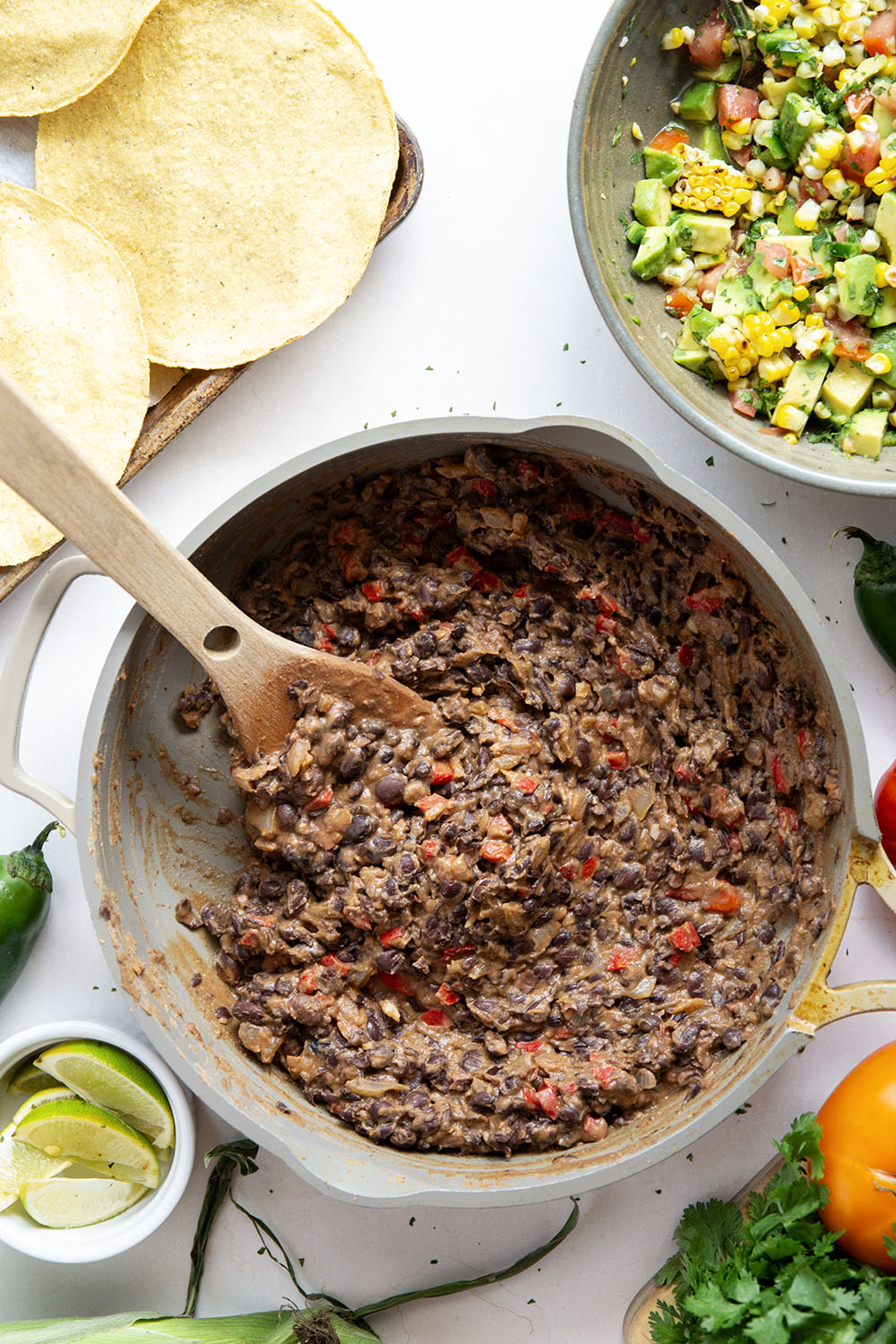 Creamy smashed black beans and a smoky grilled corn avocado salsa are piled onto these massively flavorful black bean tostadas for an easy vegetarian or vegan meal.