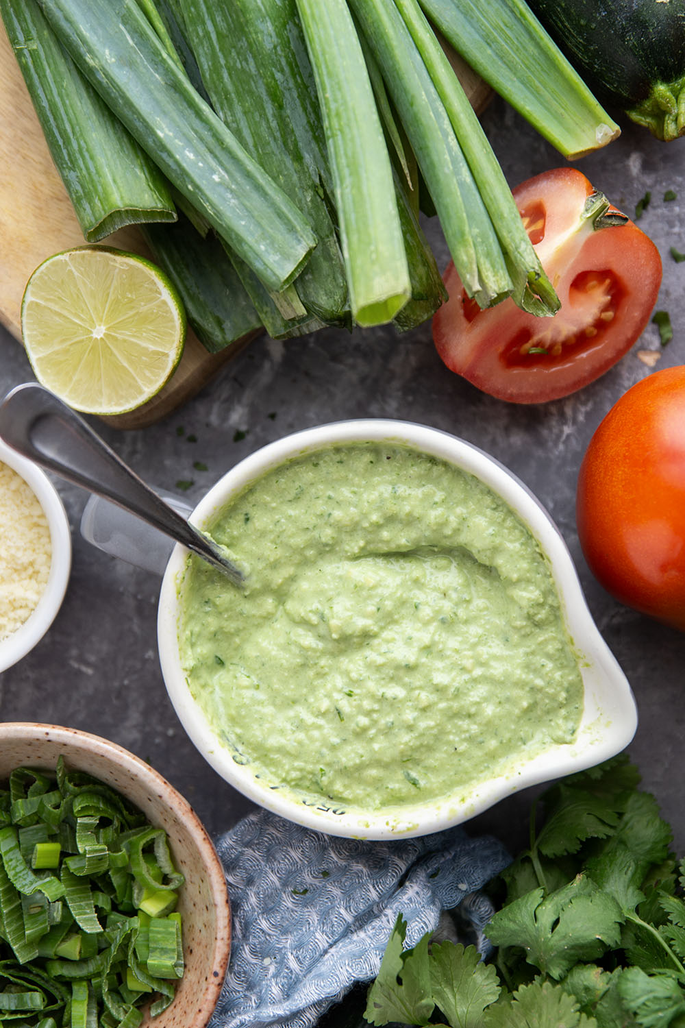 Tender zucchini is grilled until smoky and tossed with juicy summer tomatoes and a creamy avocado scallion dressing in this  flavor-packed zucchini tomato salad.