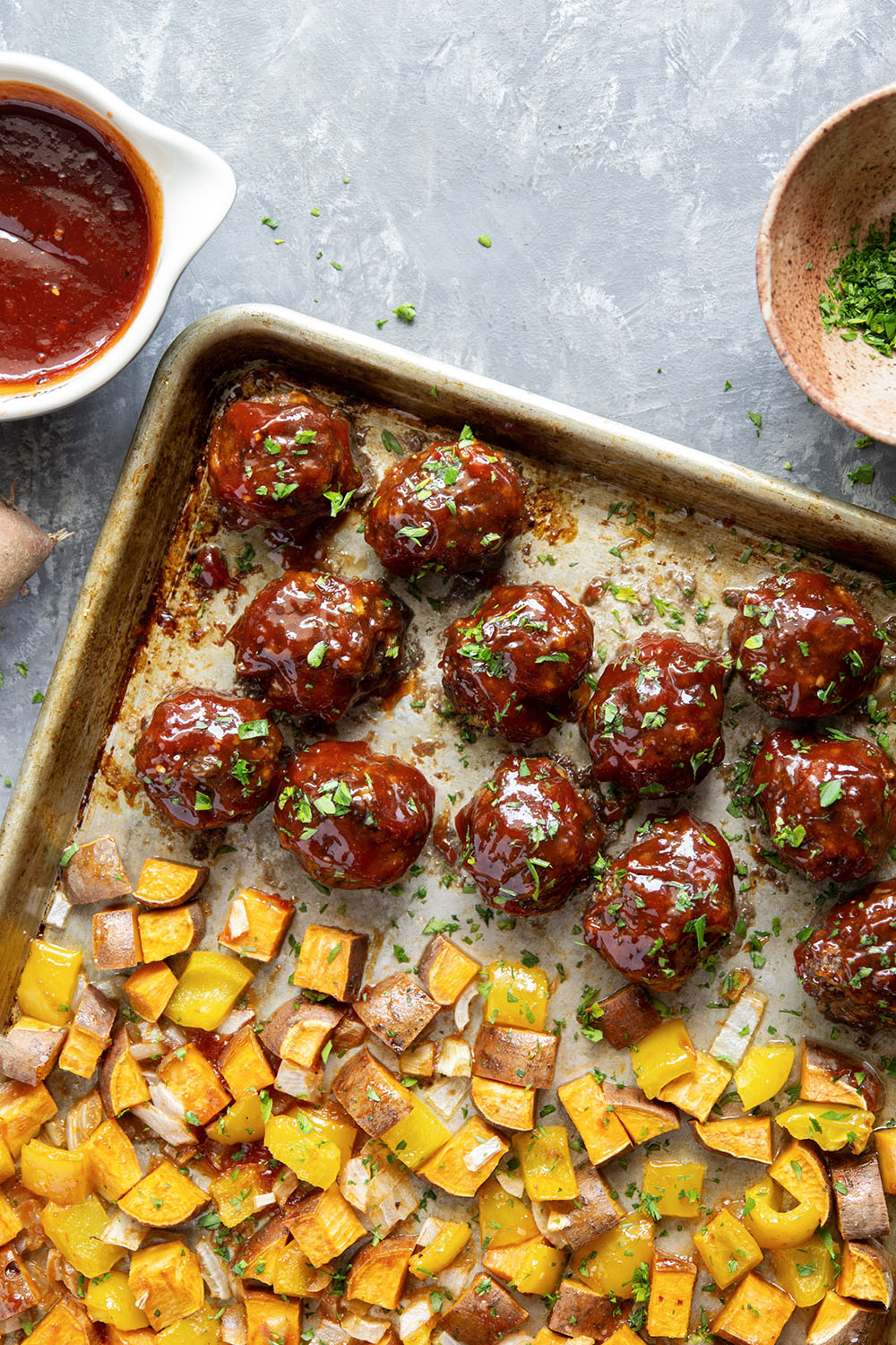 Baked in minutes on only one sheet pan, these honey BBQ meatballs are coated in a sweet and tangy homemade honey BBQ sauce and roasted alongside tender sweet potatoes.