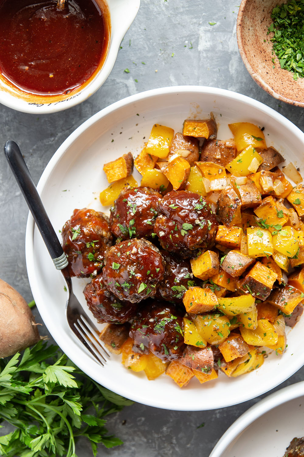 Baked in minutes on only one sheet pan, these honey BBQ meatballs are coated in a sweet and tangy homemade honey BBQ sauce and roasted alongside tender sweet potatoes.