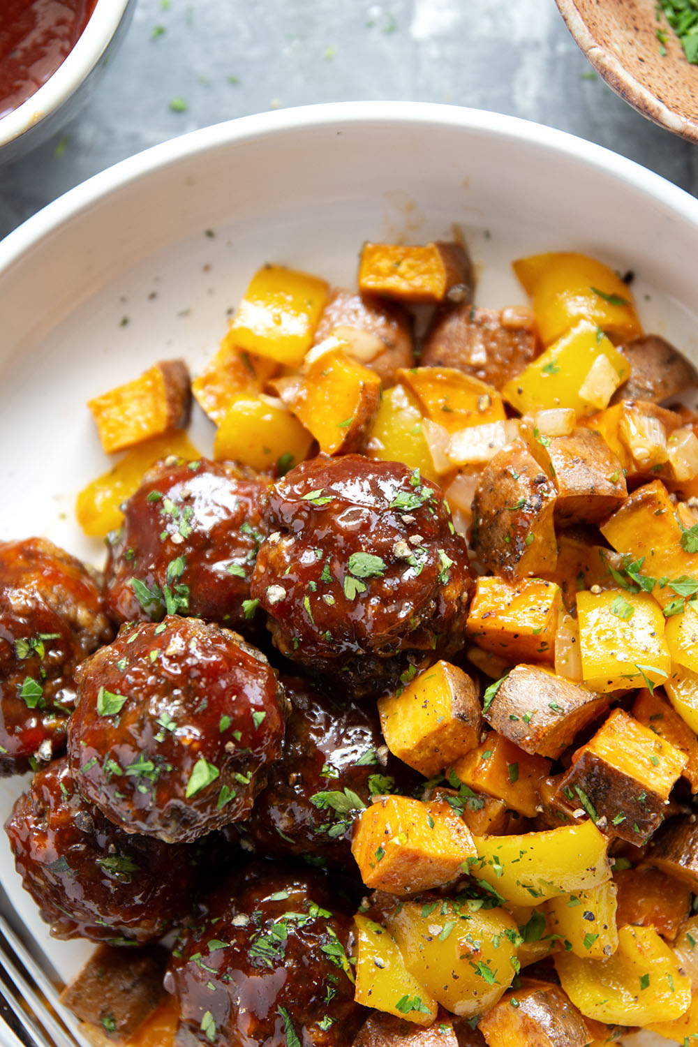 Baked in minutes on only one sheet pan, these honey BBQ meatballs are coated in a sweet and tangy homemade honey BBQ sauce and roasted alongside tender sweet potatoes.
