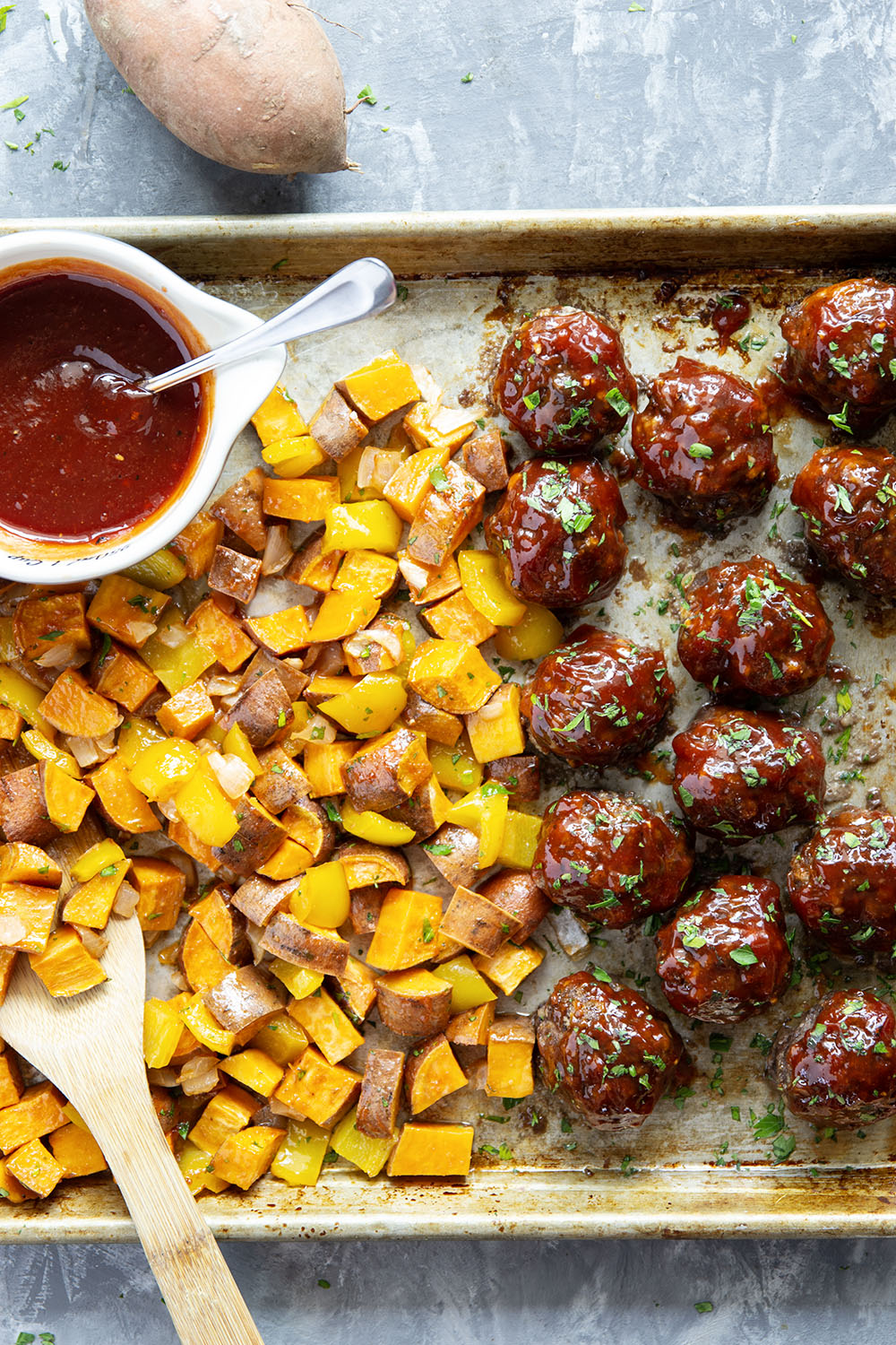 Baked in minutes on only one sheet pan, these honey BBQ meatballs are coated in a sweet and tangy homemade honey BBQ sauce and roasted alongside tender sweet potatoes.