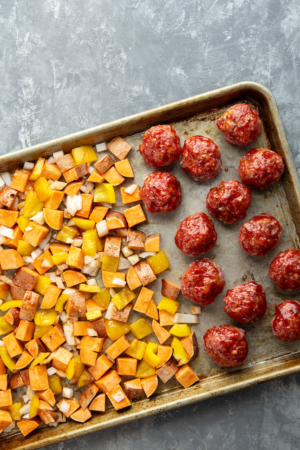 Baked in minutes on only one sheet pan, these honey BBQ meatballs are coated in a sweet and tangy homemade honey BBQ sauce and roasted alongside tender sweet potatoes.