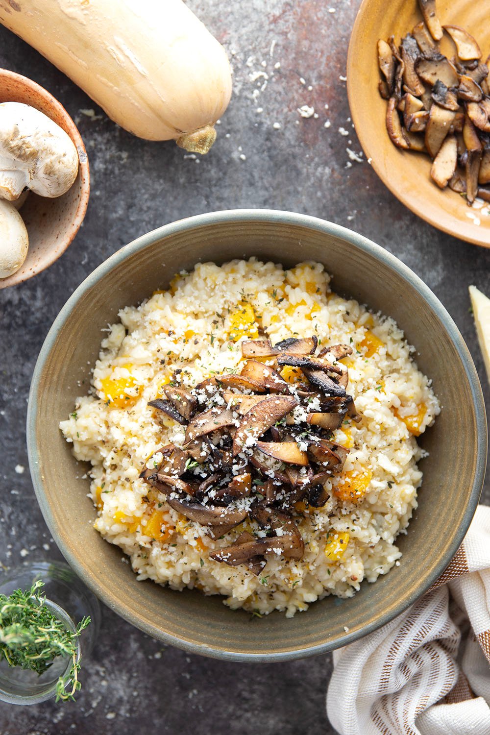 Rich and creamy butternut squash risotto is cooked with plenty of tender butternut squash cubes and nutty asiago cheese and served with crispy fried mushrooms on top.