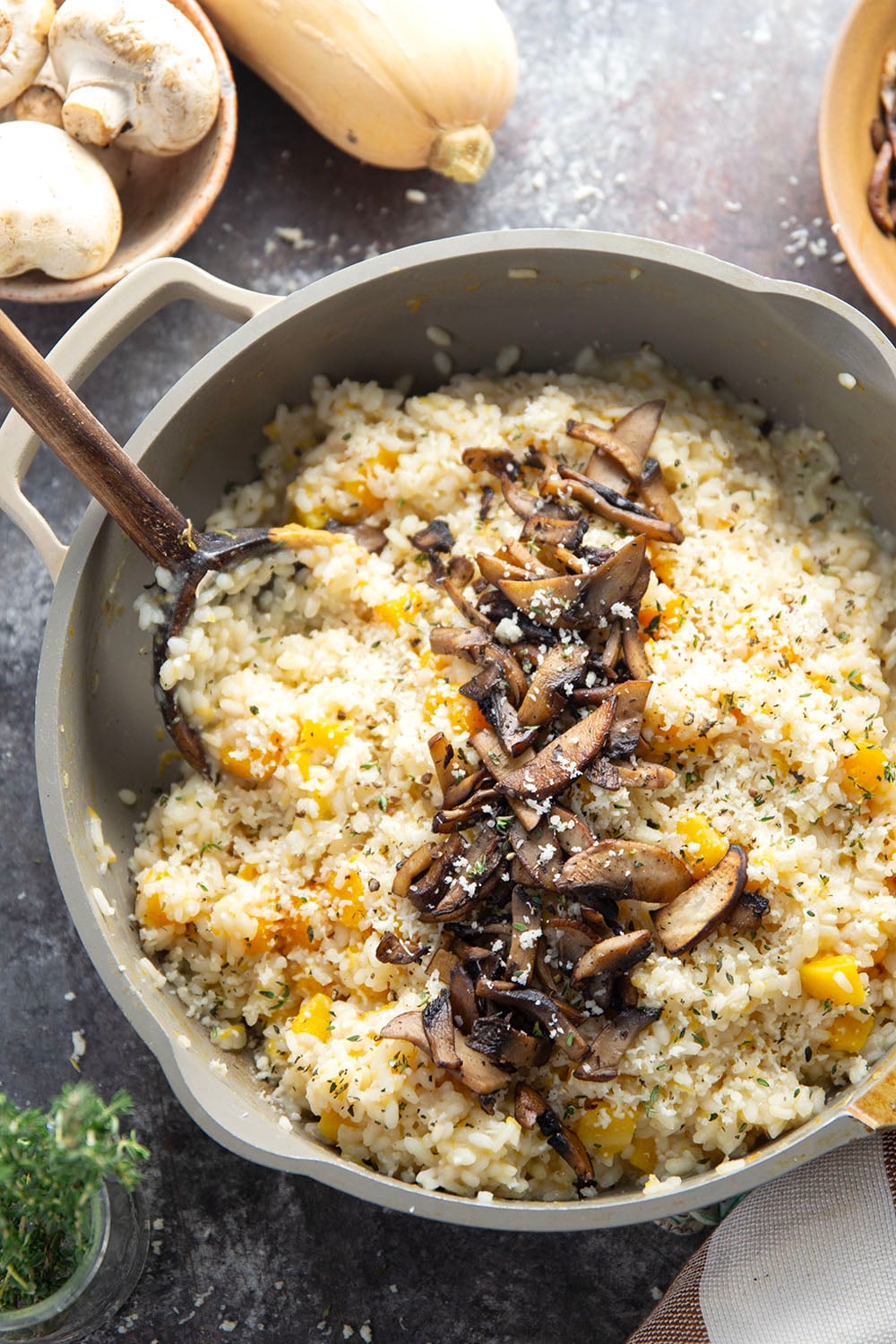Rich and creamy butternut squash risotto is cooked with plenty of tender butternut squash cubes and nutty asiago cheese and served with crispy fried mushrooms on top.
