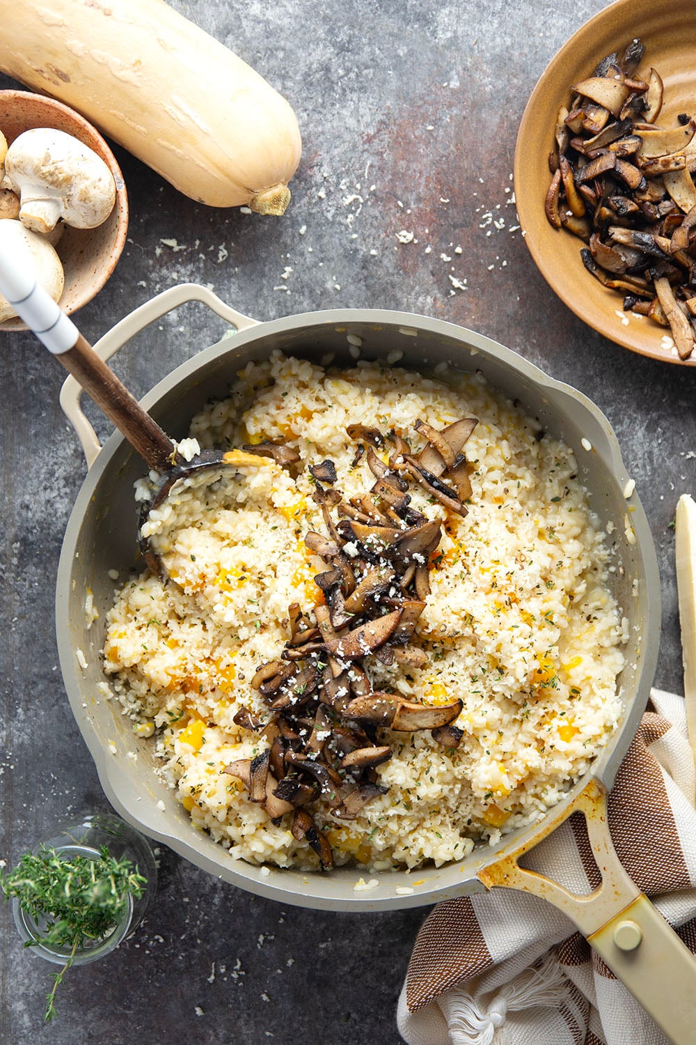 Rich and creamy butternut squash risotto is cooked with plenty of tender butternut squash cubes and nutty asiago cheese and served with crispy fried mushrooms on top.
