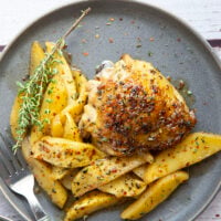 Baked alongside tender fall apples in a sweet and spicy chili maple glaze, these maple chicken thighs are a quick and flavorful fall dinner for any occasion.