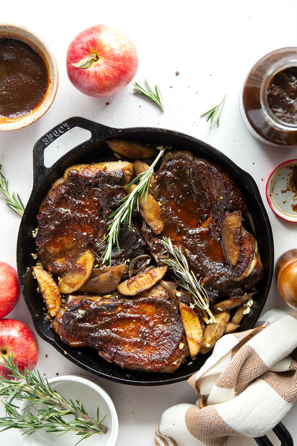 Baked alongside tender apples and glazed in a sweet apple butter sauce, these apple butter pork chops are a quick weeknight fall dinner that comes together in minutes.