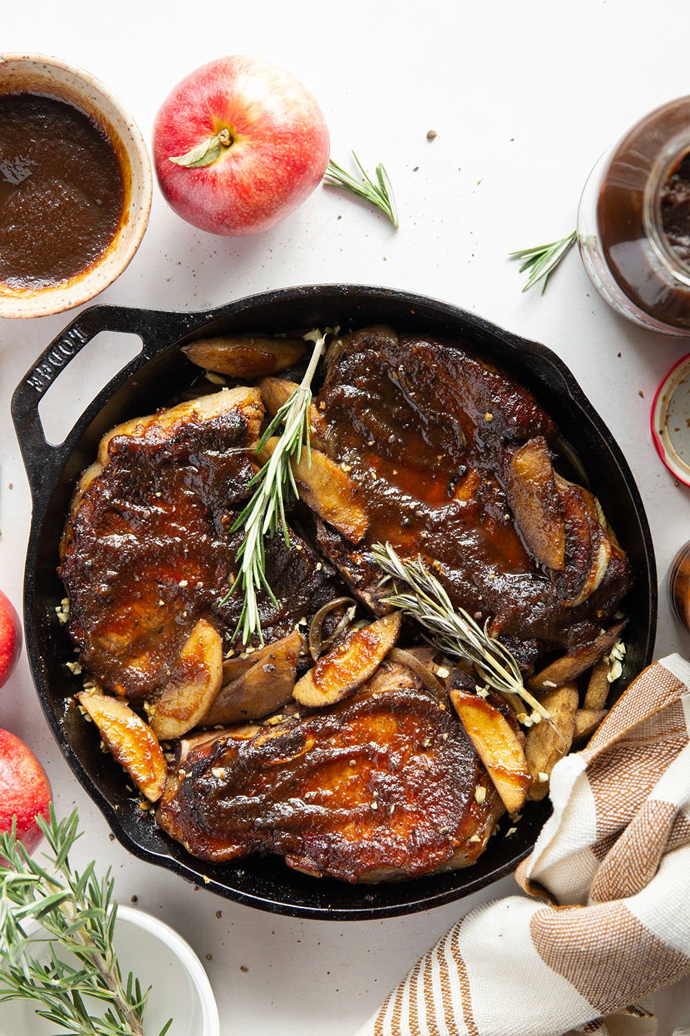 Baked alongside tender apples and glazed in a sweet apple butter sauce, these apple butter pork chops are a quick weeknight fall dinner that comes together in minutes.