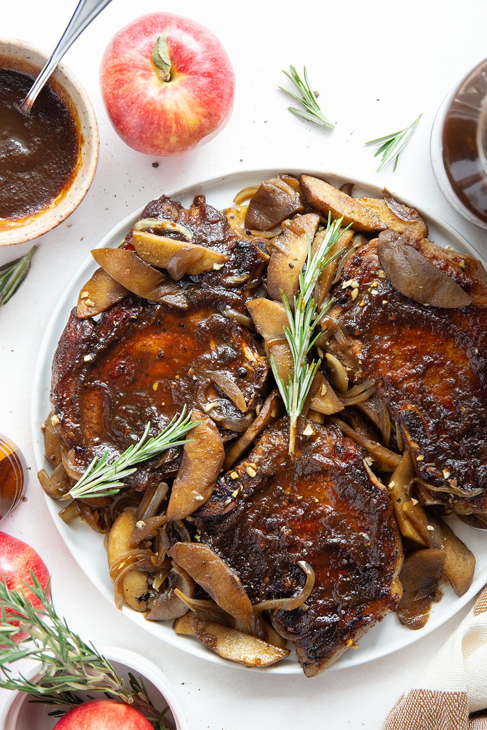 Baked alongside tender apples and glazed in a sweet apple butter sauce, these apple butter pork chops are a quick weeknight fall dinner that comes together in minutes.