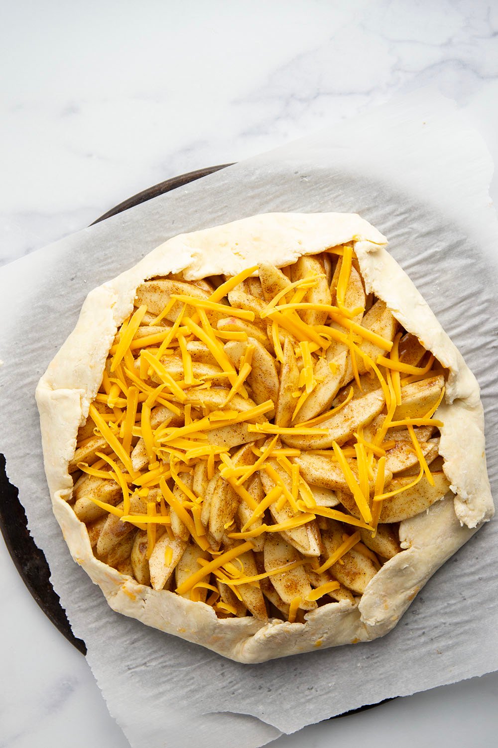 Baked with cheddar cheese in both the flaky crust and tender apple filling, this cheddar apple galette is a simple free-form pastry that's the perfect mix of sweet and savory!