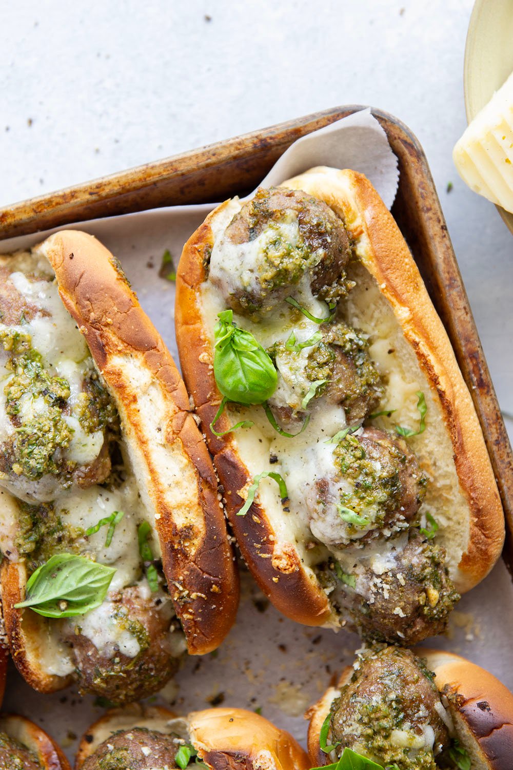 Juicy turkey meatballs are tossed in flavorful basil pesto and baked with lots of gooey havarti cheese in this pesto meatball sandwich.