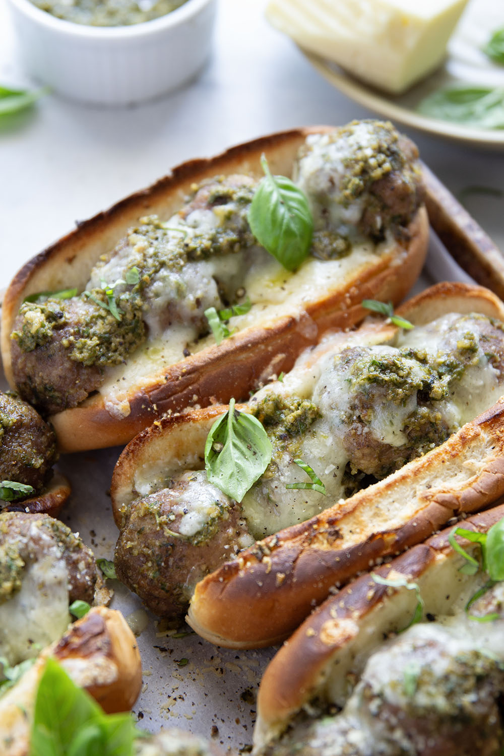 Juicy turkey meatballs are tossed in flavorful basil pesto and baked with lots of gooey havarti cheese in this pesto meatball sandwich.