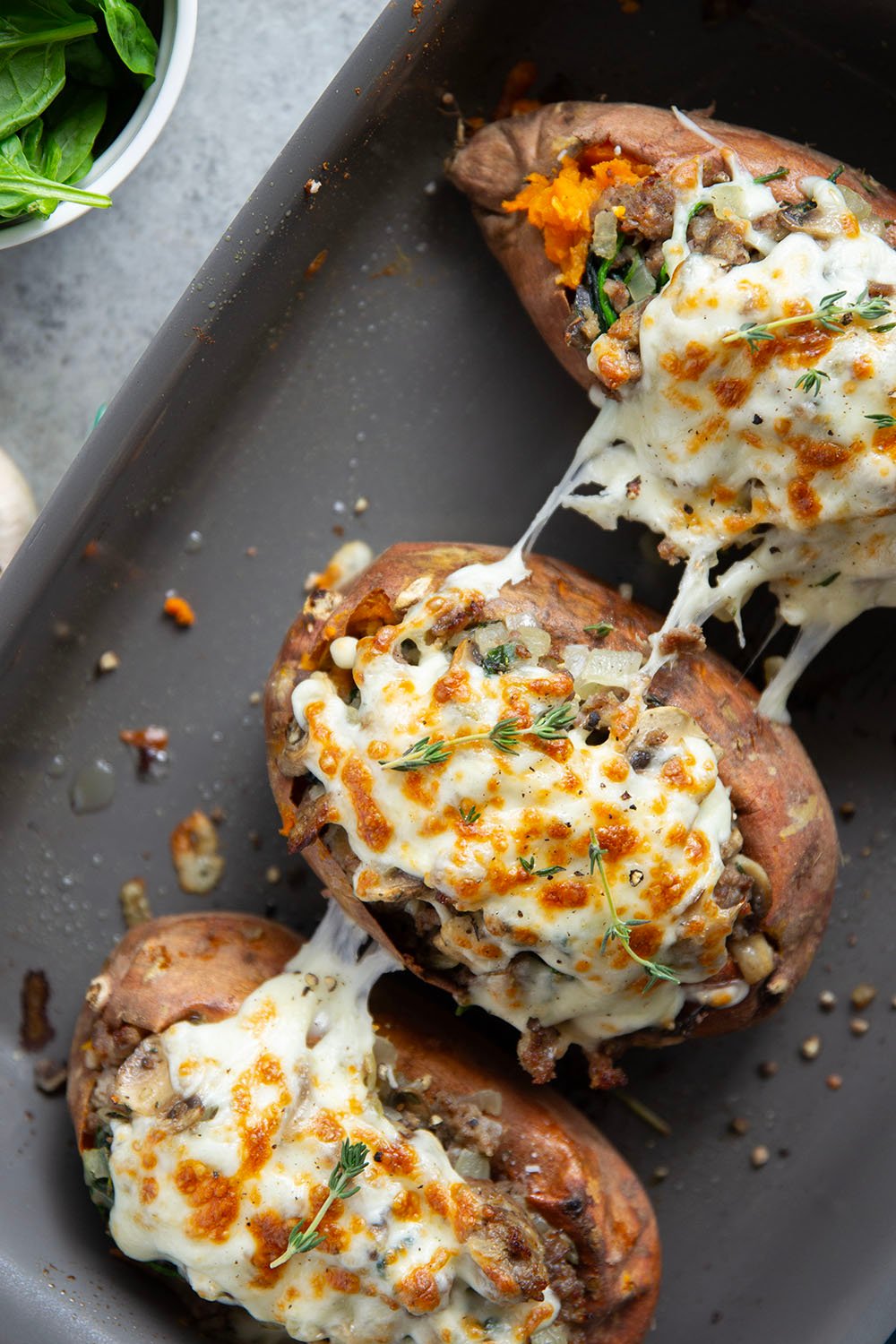 These mushroom sausage stuffed sweet potatoes feature a flavorful Italian sausage mushroom filling stuffed into fluffy baked sweet potatoes and baked with lots of gooey mozzarella on top.