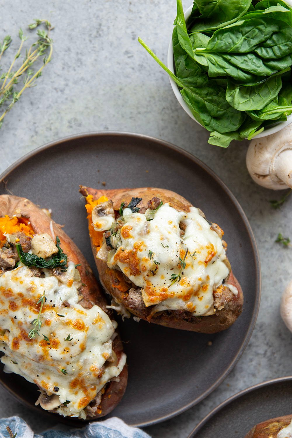 These mushroom sausage stuffed sweet potatoes feature a flavorful Italian sausage mushroom filling stuffed into fluffy baked sweet potatoes and baked with lots of gooey mozzarella on top.