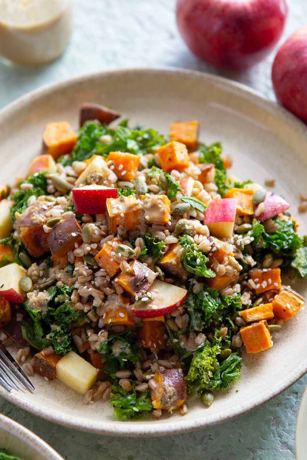 Tender roasted sweet potatoes and hearty farro add plenty of bulk to this fall-flavored sweet potato farro salad that gets dressed with a savory sesame dressing.
