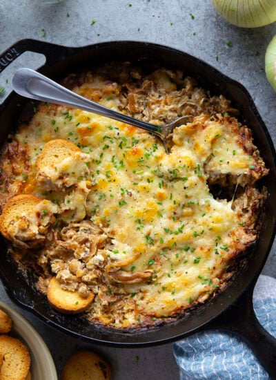 Baked with tender caramelized onions and lots of gooey cheese, this caramelized onion chickpea dip is the best hot and cheesy appetizer!