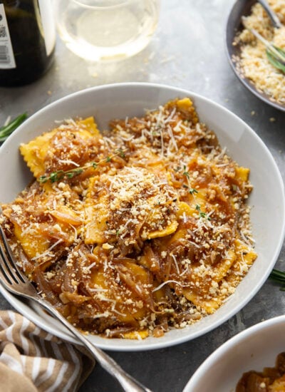 Savory caramelized onions and crispy asiago breadcrumbs dress up this French onion ravioli that makes a great side dish for any holiday meal.