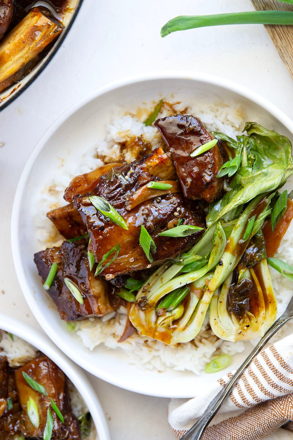 Slowly cooked in a flavorful ginger soy broth until fall-apart tender, these soy braised short ribs are easy to put together for a holiday dinner and excellent served over steamed rice with baby bok choy.