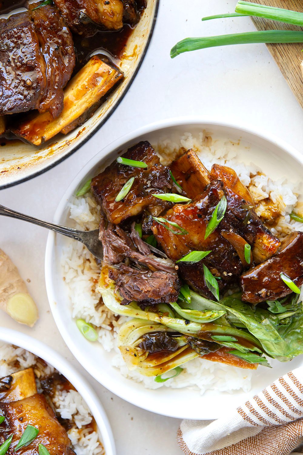 Slowly cooked in a flavorful ginger soy broth until fall-apart tender, these soy braised short ribs are easy to put together for a holiday dinner and excellent served over steamed rice with baby bok choy.