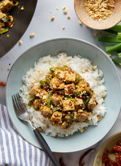 Savory and spicy kung pao tofu features tender tofu cubes cooked in a flavorful sauce with lots of green onions and chili peppers.